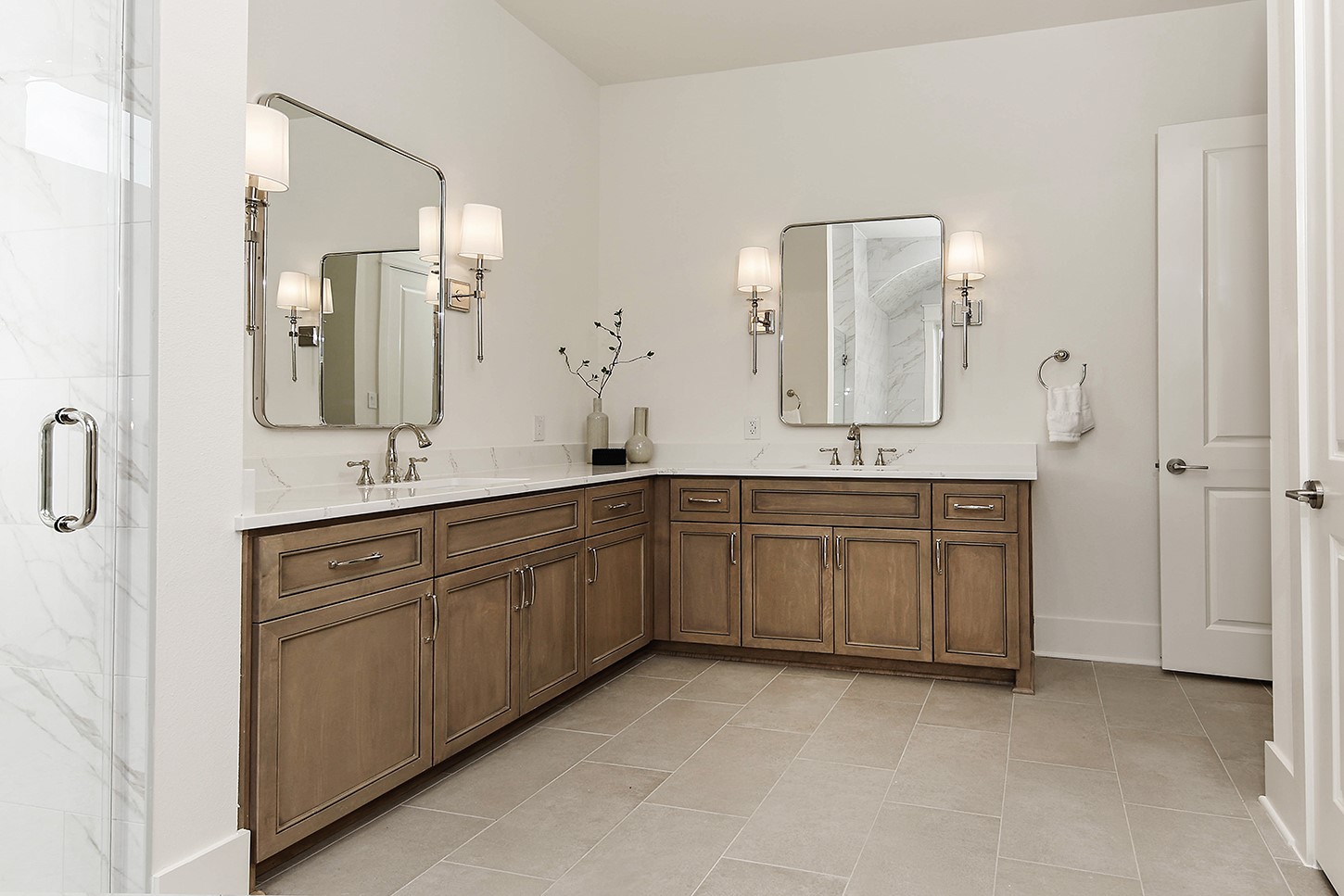 15728 Woodlife Road Willis, TX 77378 - Photo 24 of 36 Gorgeous silver sconces flank impressive-sized mirrors, along with high end plumbing fixtures and cabinet pulls.