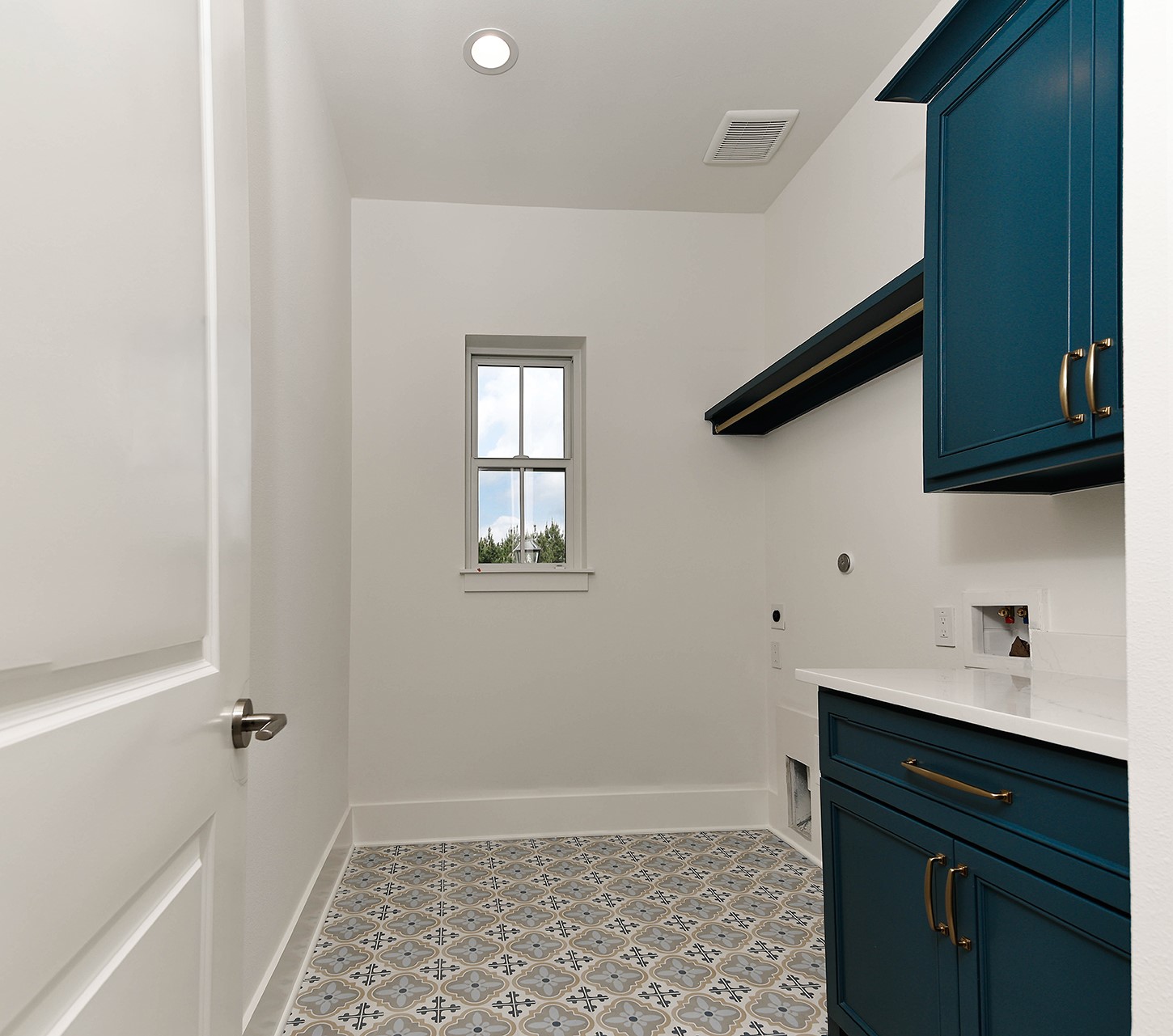 15728 Woodlife Road Willis, TX 77378 - Photo 26 of 36 Same pop of color adds such character in laundry room, along with gorgeous patterned tile floors, and convenient rod space and window is a plus.