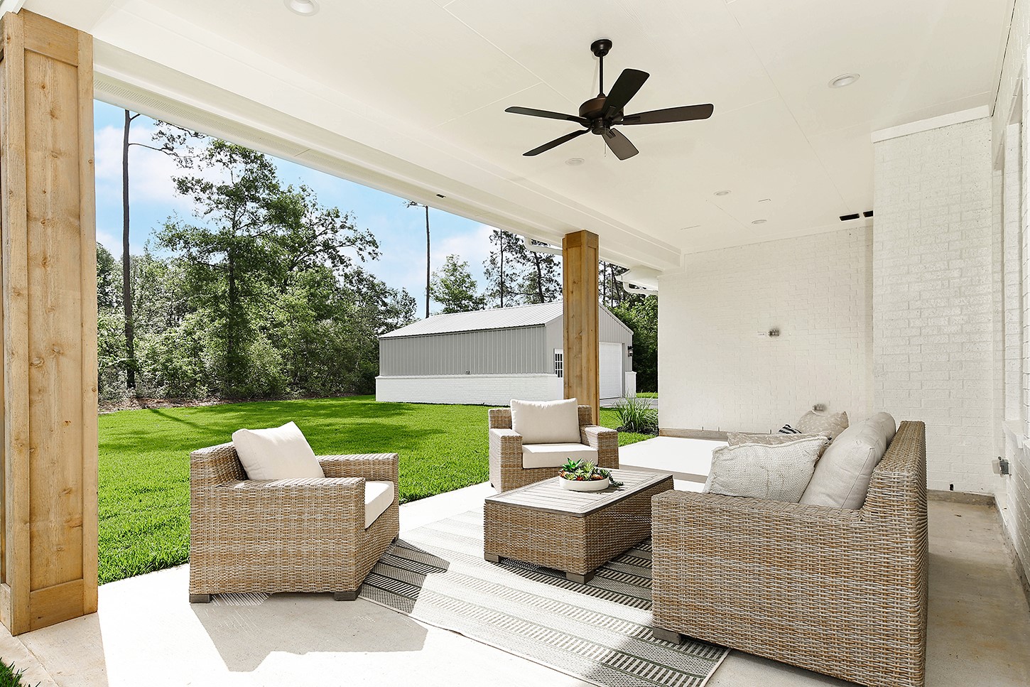 15728 Woodlife Road Willis, TX 77378 - Photo 32 of 36 Wood columns add architectural interest and character to the outdoor lanai with ceiling fan.