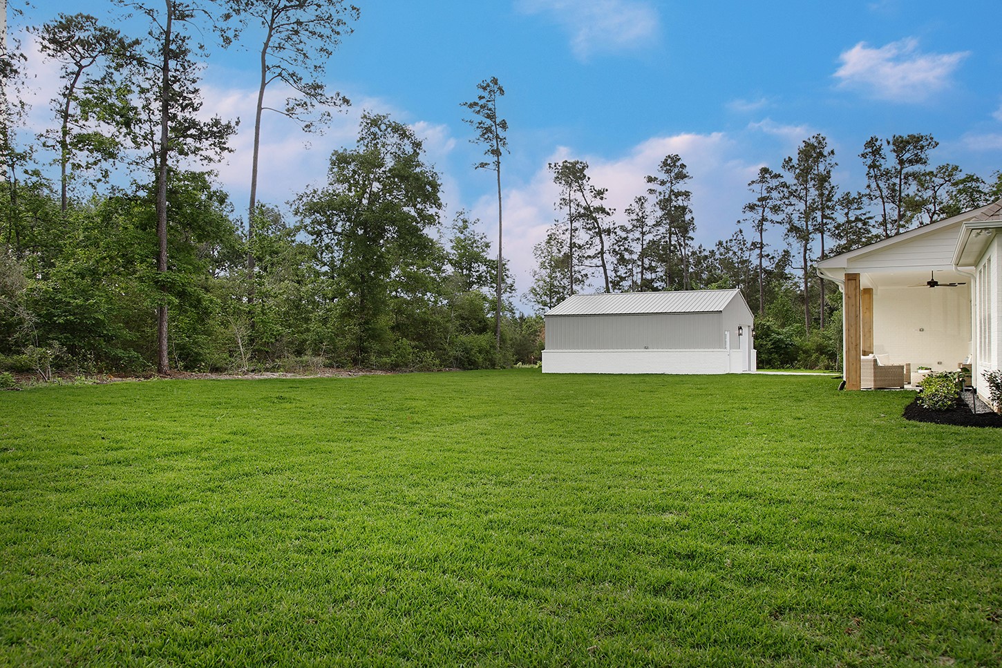 15728 Woodlife Road Willis, TX 77378 - Photo 34 of 36 Expansive lawn space in backyard surrounded by beautiful trees with convenient 24' x 30' storage building.
