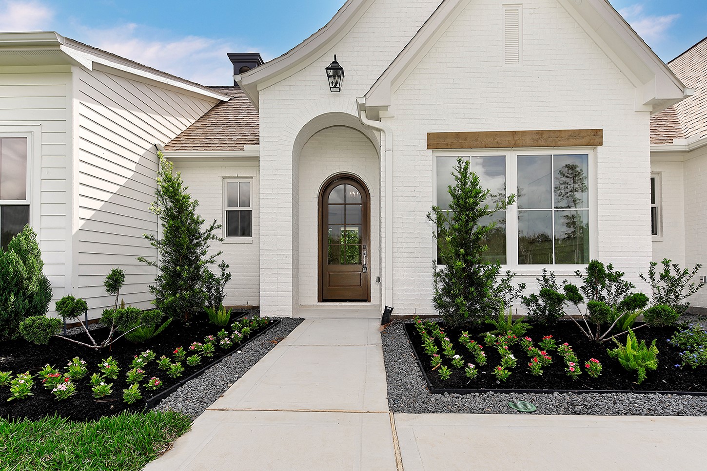 15728 Woodlife Road Willis, TX 77378 - Photo 6 of 36 Gorgeous brick with custom arched wood door sets the tone for what's to come. Rustic wood beam window header is striking and adds architectural interest.
