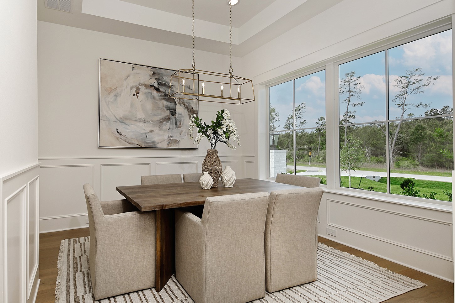 15728 Woodlife Road Willis, TX 77378 - Photo 9 of 36 Paneled wainscoting adds depth and style as does the recessed ceiling with fabulous modern linear open frame chandelier.