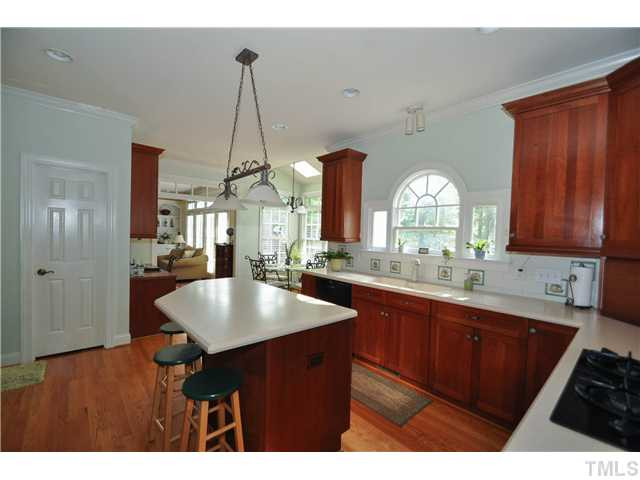 1805 Liatris Lane Raleigh, NC 27613 - Photo 10 of 25 Cook friendly kitchen with a new microwave and dishwasher. Large center island is ideal for food prep with a eat-in bar area as well. Perfect spot to entertain while cooking! Kitchen