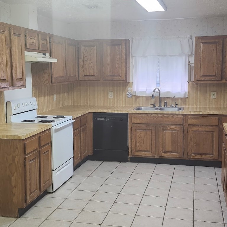 6443 Allerton Street Houston, TX 77084 - Photo 2 of 18 a kitchen with a stove sink and cabinets
