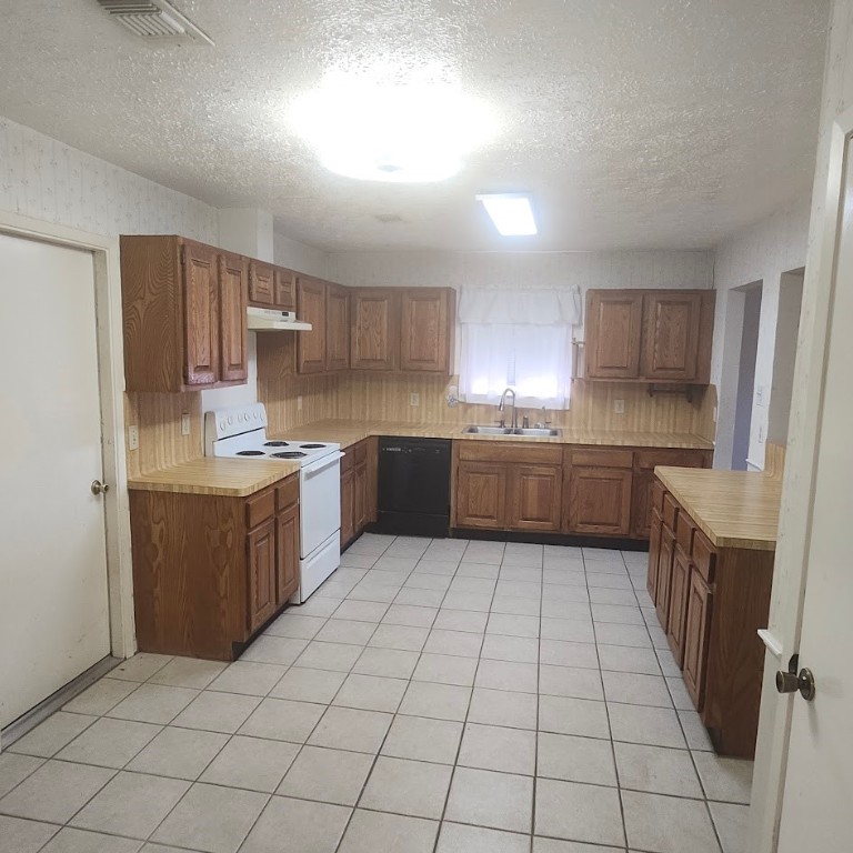 6443 Allerton Street Houston, TX 77084 - Photo 3 of 18 a kitchen with stainless steel appliances granite countertop a refrigerator and a stove top oven
