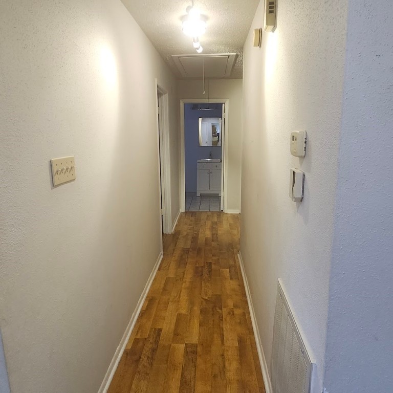 6443 Allerton Street Houston, TX 77084 - Photo 6 of 18 a view of a hallway with wooden floor
