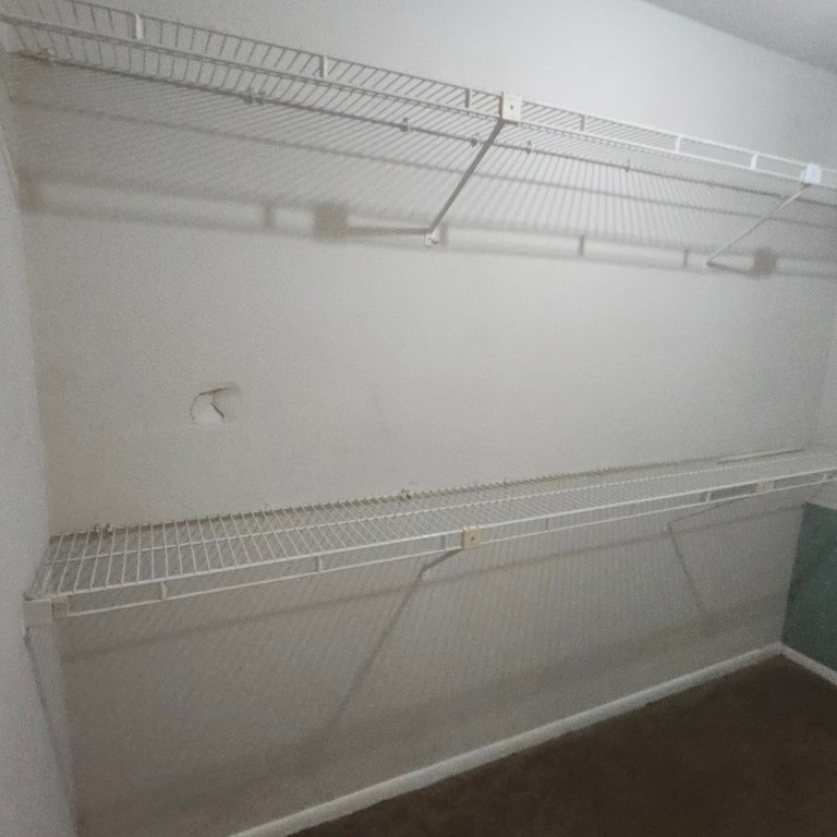 6443 Allerton Street Houston, TX 77084 - Photo 10 of 18 a view of a closet with wooden floor