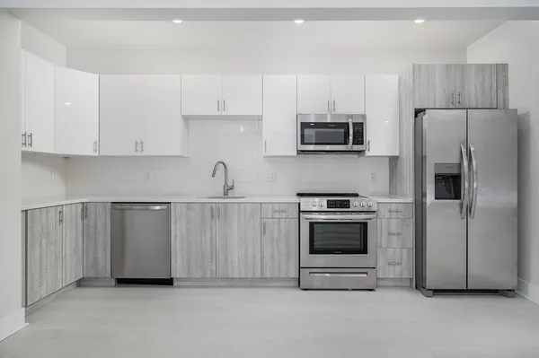 a kitchen with cabinets and stainless steel appliances