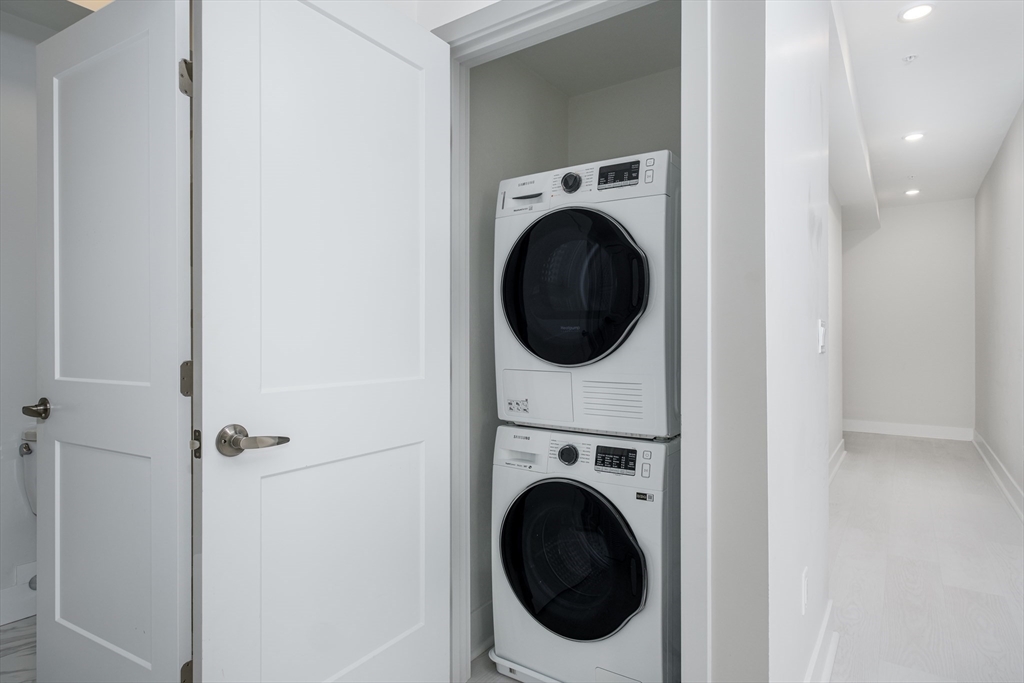 1540 North Shore Road, Unit 302 Revere, MA 02151 - Photo 4 of 15 a view of a hallway with washer and dryer