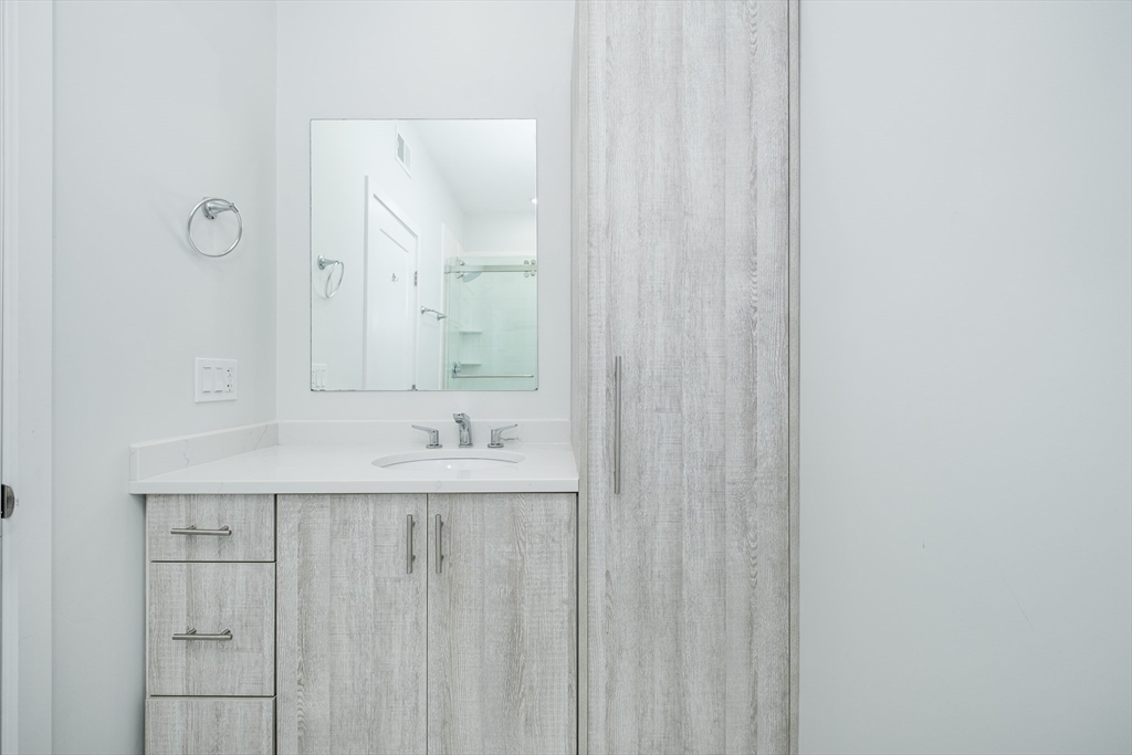 1540 North Shore Road, Unit 302 Revere, MA 02151 - Photo 6 of 15 a bathroom with a sink and a mirror