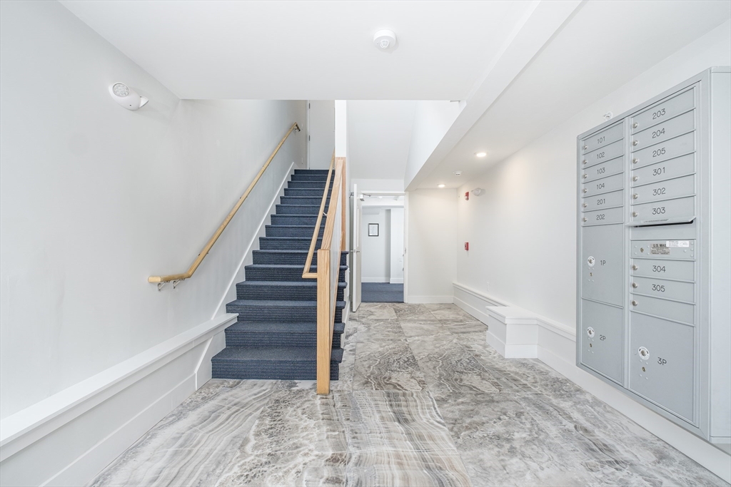 1540 North Shore Road, Unit 302 Revere, MA 02151 - Photo 10 of 15 a view of hallway with stairs and wooden floor