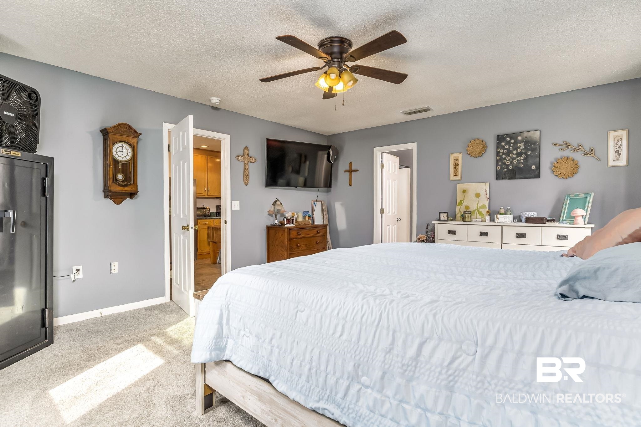 12199 Bay Road West Foley, AL 36535 - Photo 30 of 62 Bedroom with light carpet, a textured ceiling, and ceiling fan