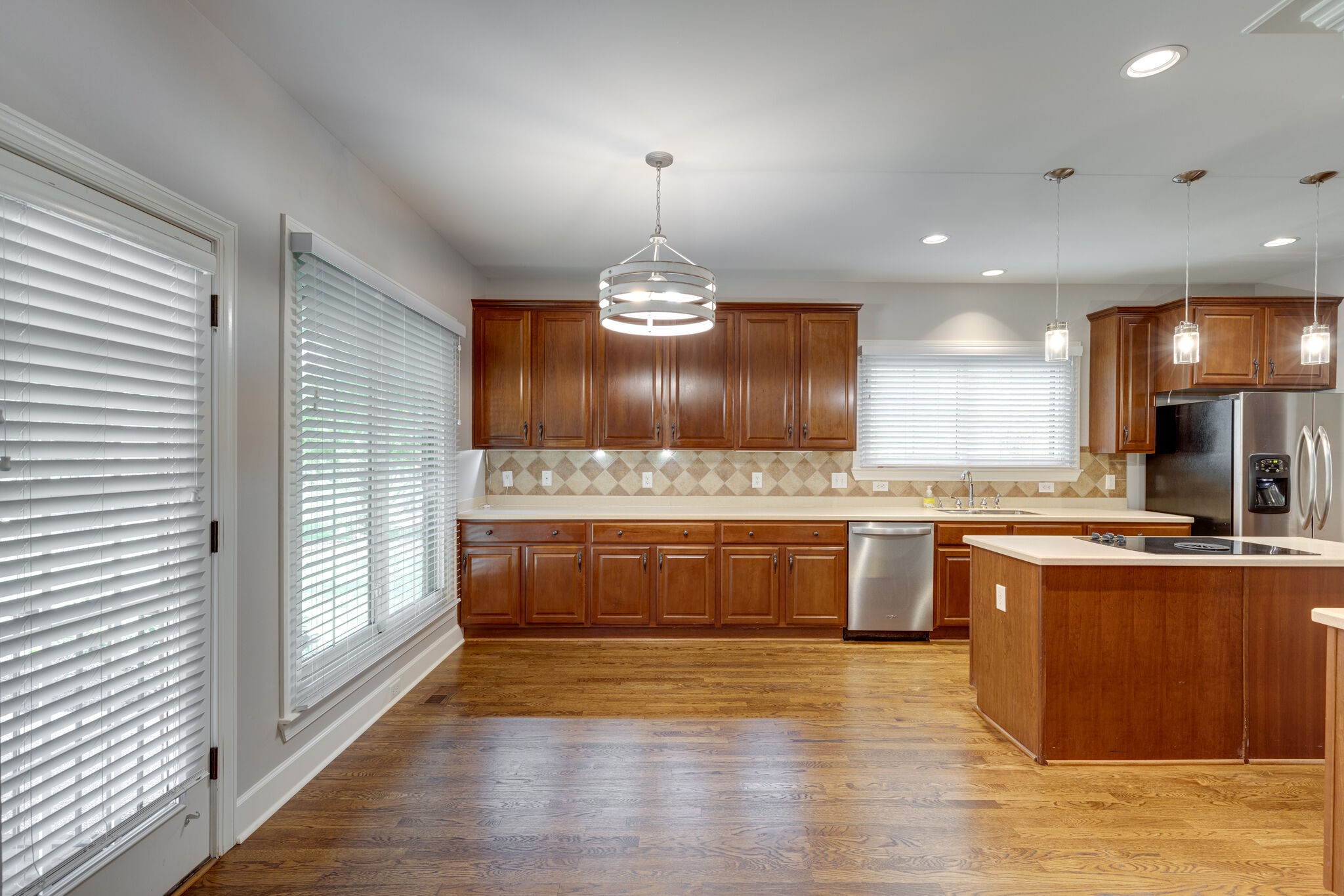 119 Richards Glen Drive Franklin, TN 37067 - Photo 9 of 41 a large kitchen with granite countertop a stove top oven a sink a counter space and wooden floor