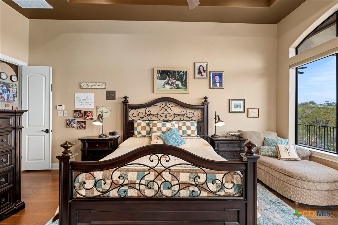 1039 Bluewater Place Spring Branch, TX 78070 - Photo 36 of 48 a bedroom with furniture and a floor to ceiling window