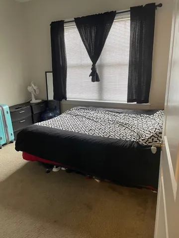 a bed sitting in a room next to a window