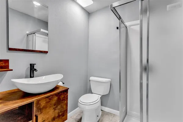 a bathroom with a toilet a sink and mirror