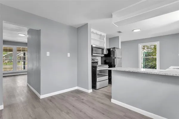 a view of kitchen with furniture and wooden floor