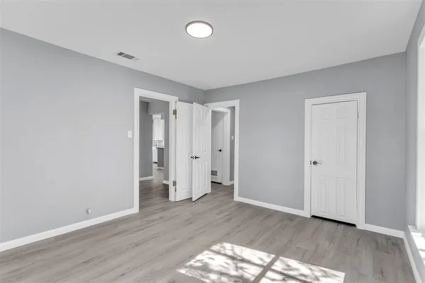 a view of an empty room and wooden floor