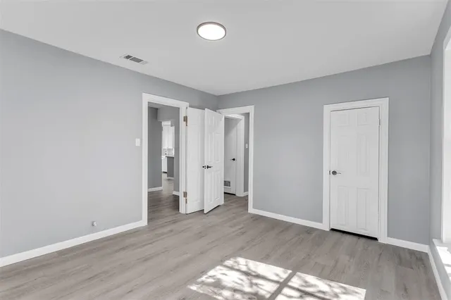 a view of an empty room and wooden floor