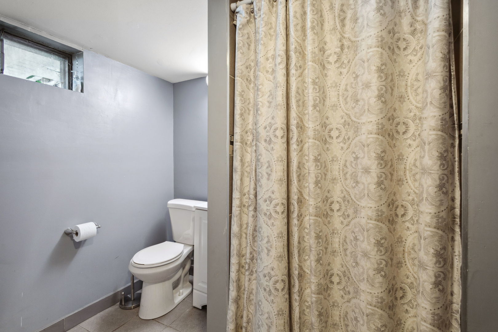 3116 191st Place Lansing, IL 60438 - Photo 14 of 19 a white toilet sitting next to a shower curtain