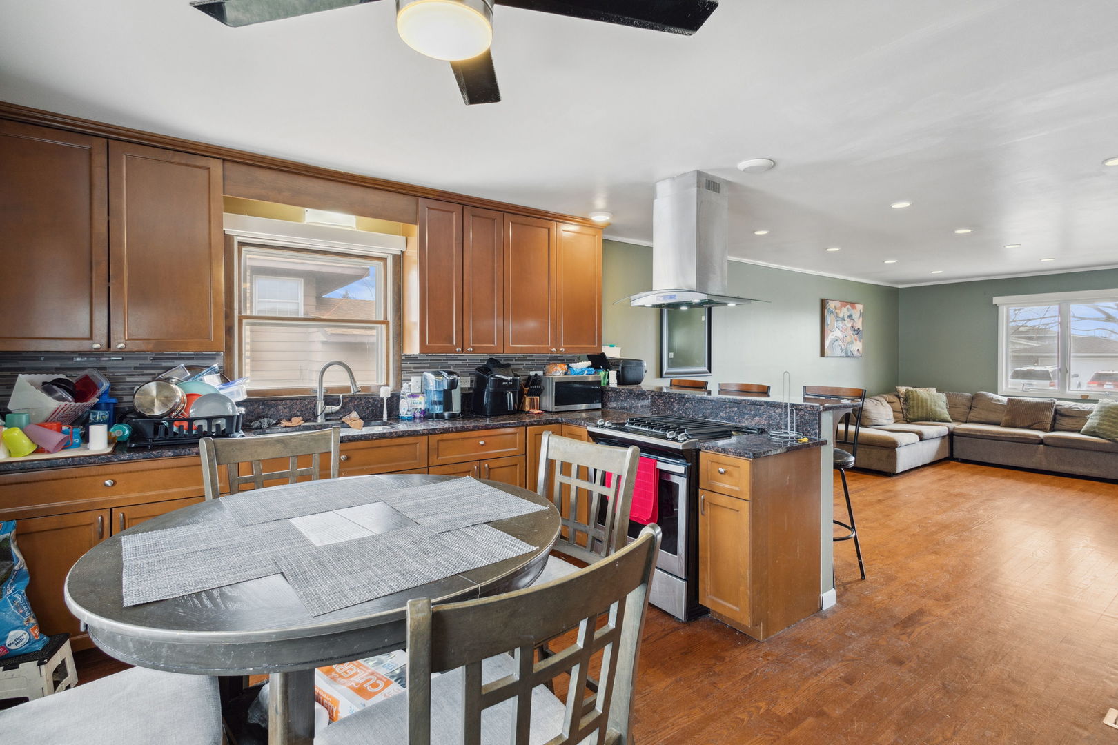 3116 191st Place Lansing, IL 60438 - Photo 7 of 19 a kitchen with stainless steel appliances granite countertop a stove a kitchen island a dining table and chairs
