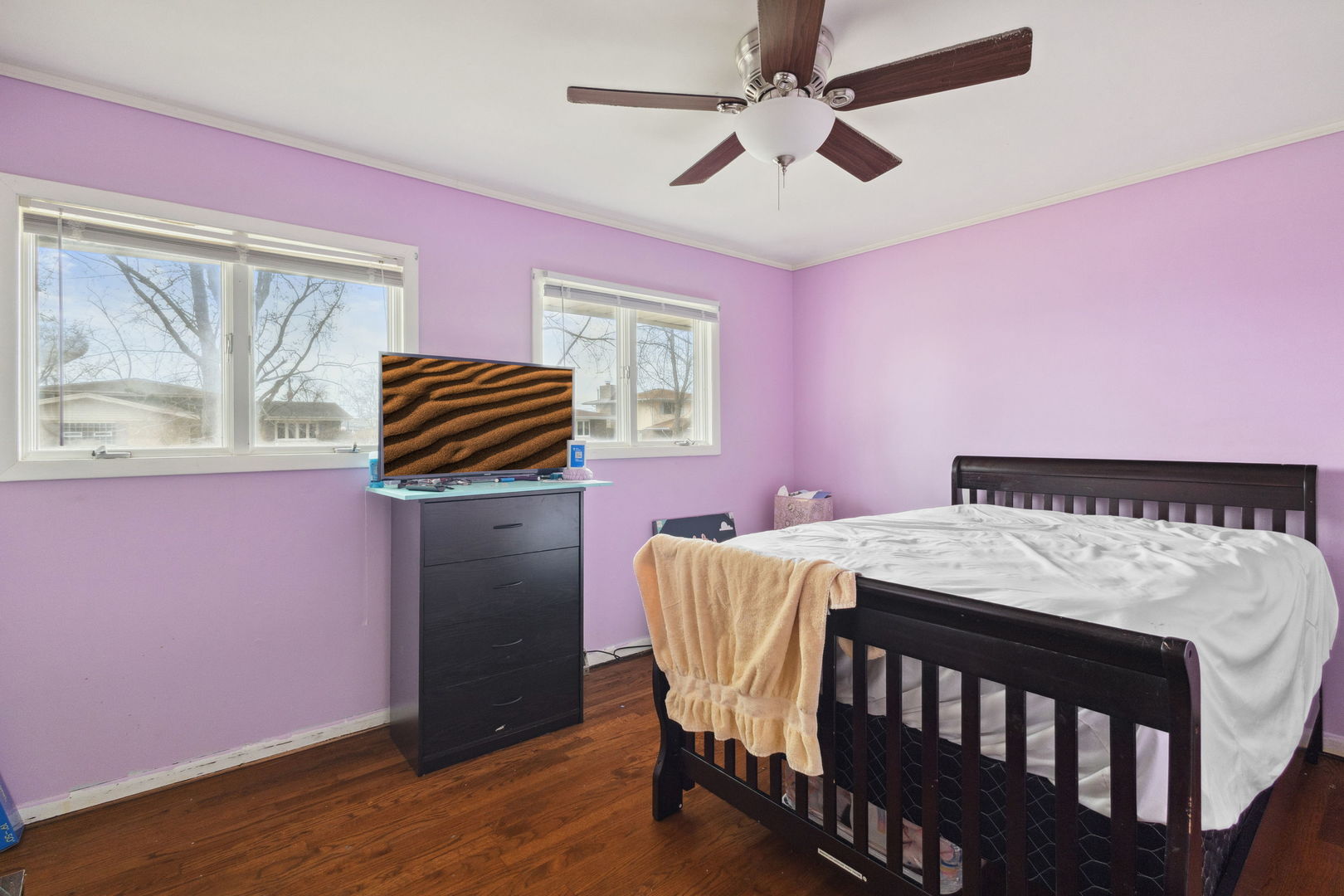 3116 191st Place Lansing, IL 60438 - Photo 10 of 19 a bedroom with a bed a chandelier and pink walls