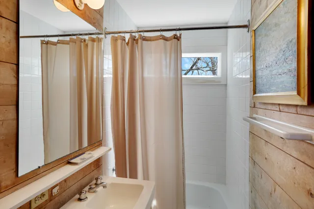a view of a bathroom with a bathtub and a shower