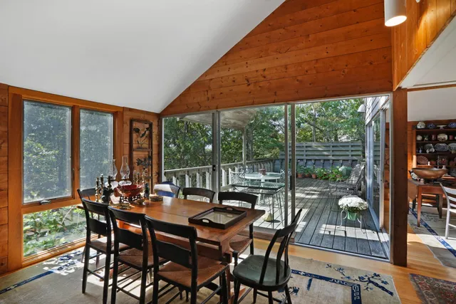 a dining room with furniture and a garden view