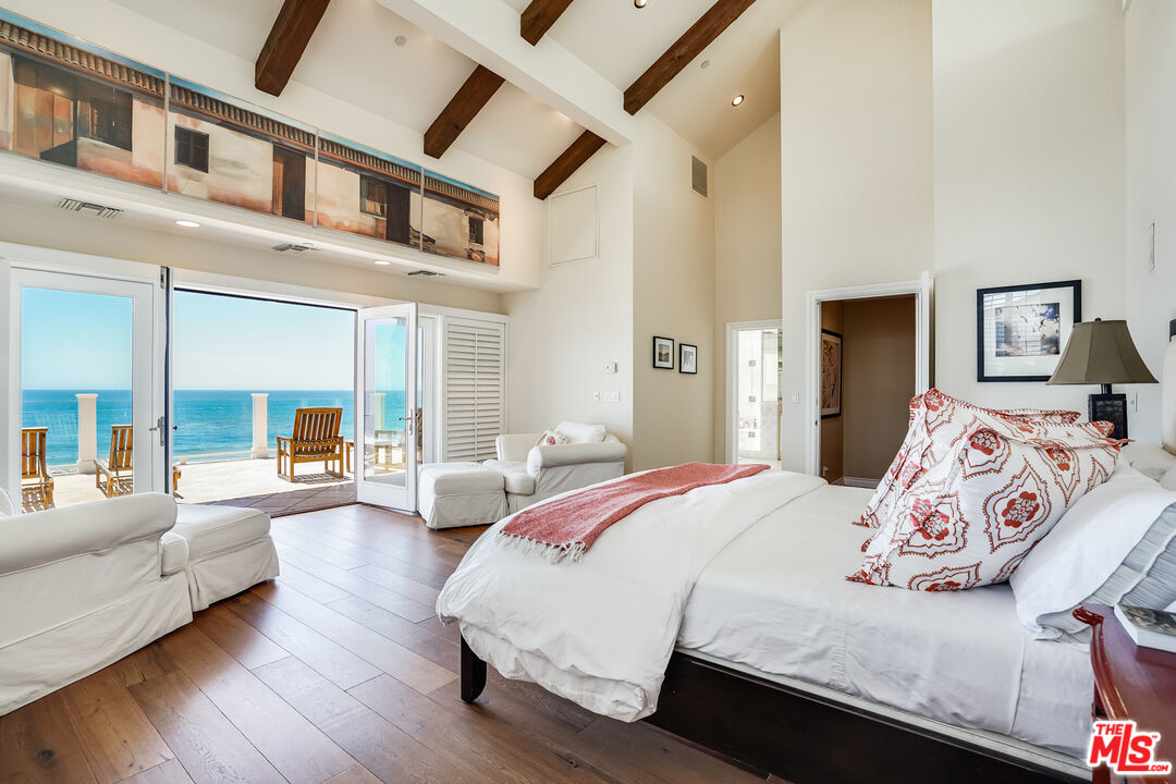 31444 Broad Beach Road Malibu, CA 90265 - Photo 13 of 36 a bedroom with a large bed couch and a large window