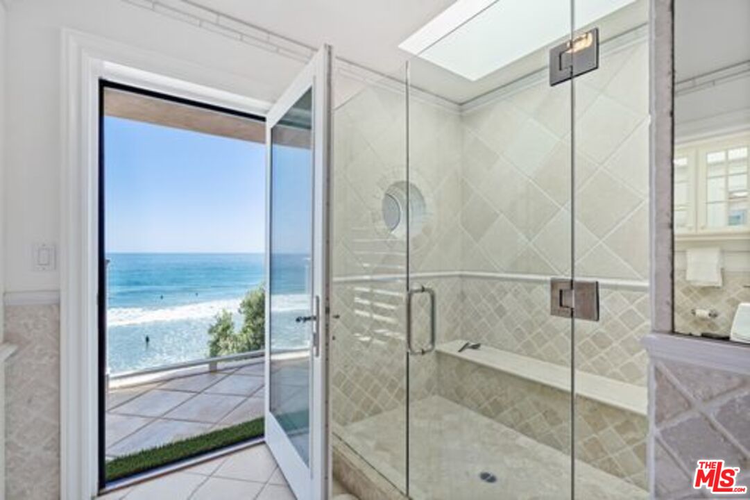 31444 Broad Beach Road Malibu, CA 90265 - Photo 18 of 36 a bathroom with a glass shower door