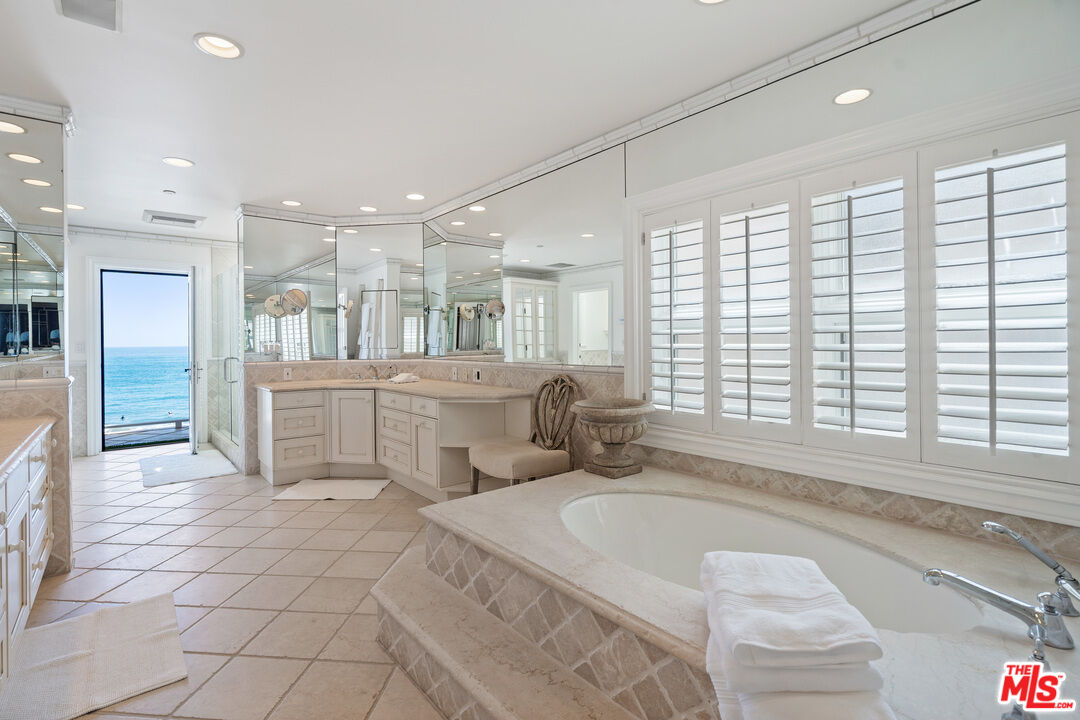 31444 Broad Beach Road Malibu, CA 90265 - Photo 19 of 36 a large white bathroom with a large tub shower and sink