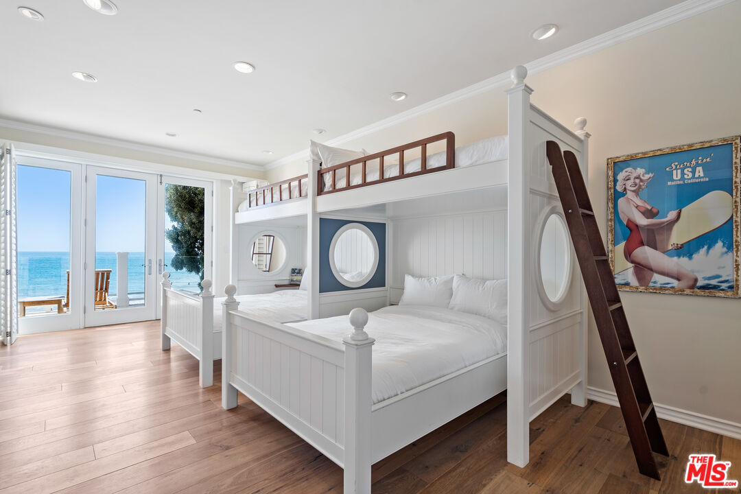 31444 Broad Beach Road Malibu, CA 90265 - Photo 23 of 36 a bedroom with a bed and a large mirror on the dresser