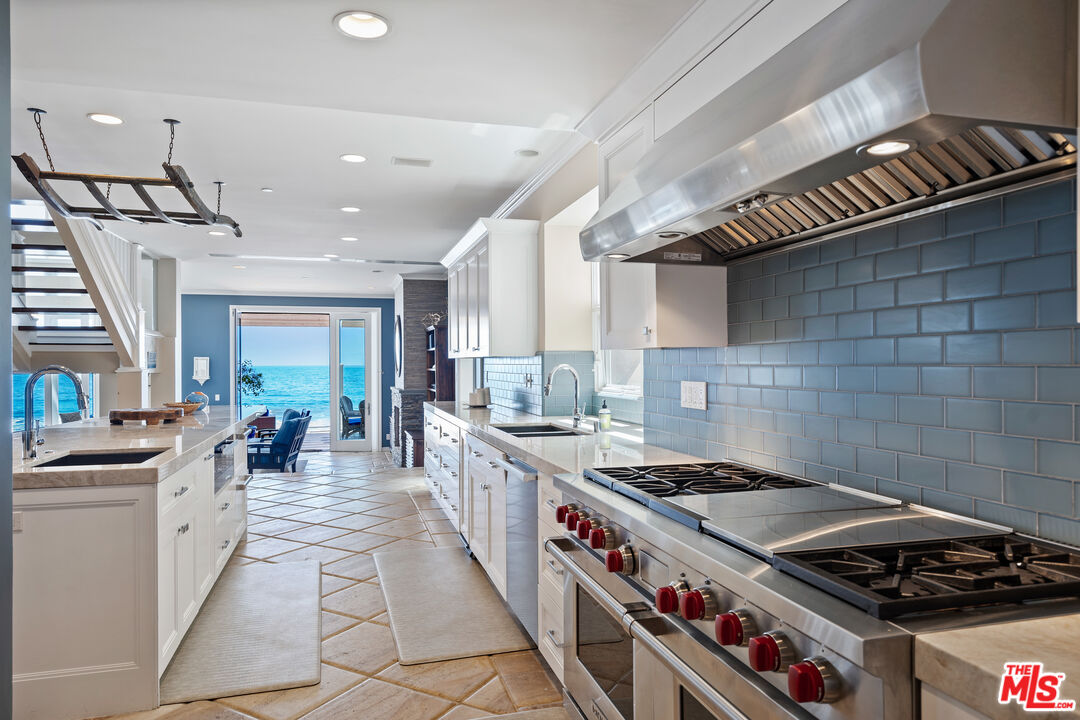 31444 Broad Beach Road Malibu, CA 90265 - Photo 10 of 36 a kitchen with a stove a sink and a refrigerator