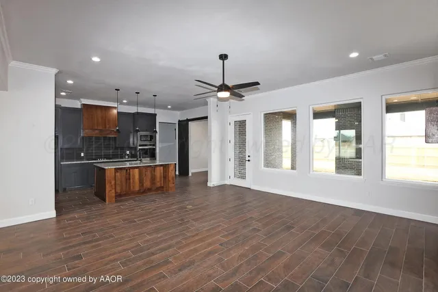 a view of kitchen with sink and refrigerator