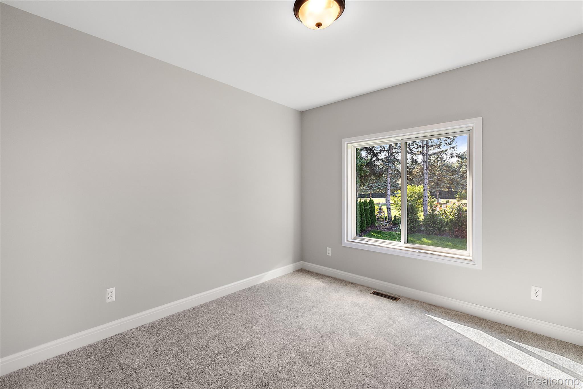 8267 Sandi Lane Romeo, MI 48065 - Photo 31 of 46 Neutral-toned walls, grey carpeting, and a window with exterior landscaping