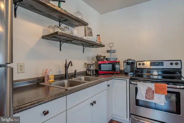 a kitchen with stainless steel appliances granite countertop a sink and cabinets