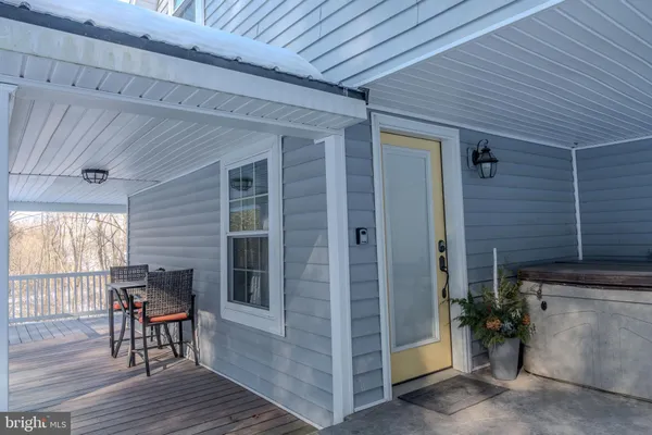 a view of a porch with furniture and wooden floor
