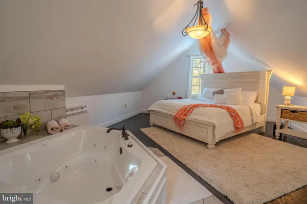a bedroom with a bed and a chandelier