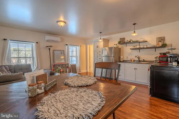 a living room with furniture rug and dining table