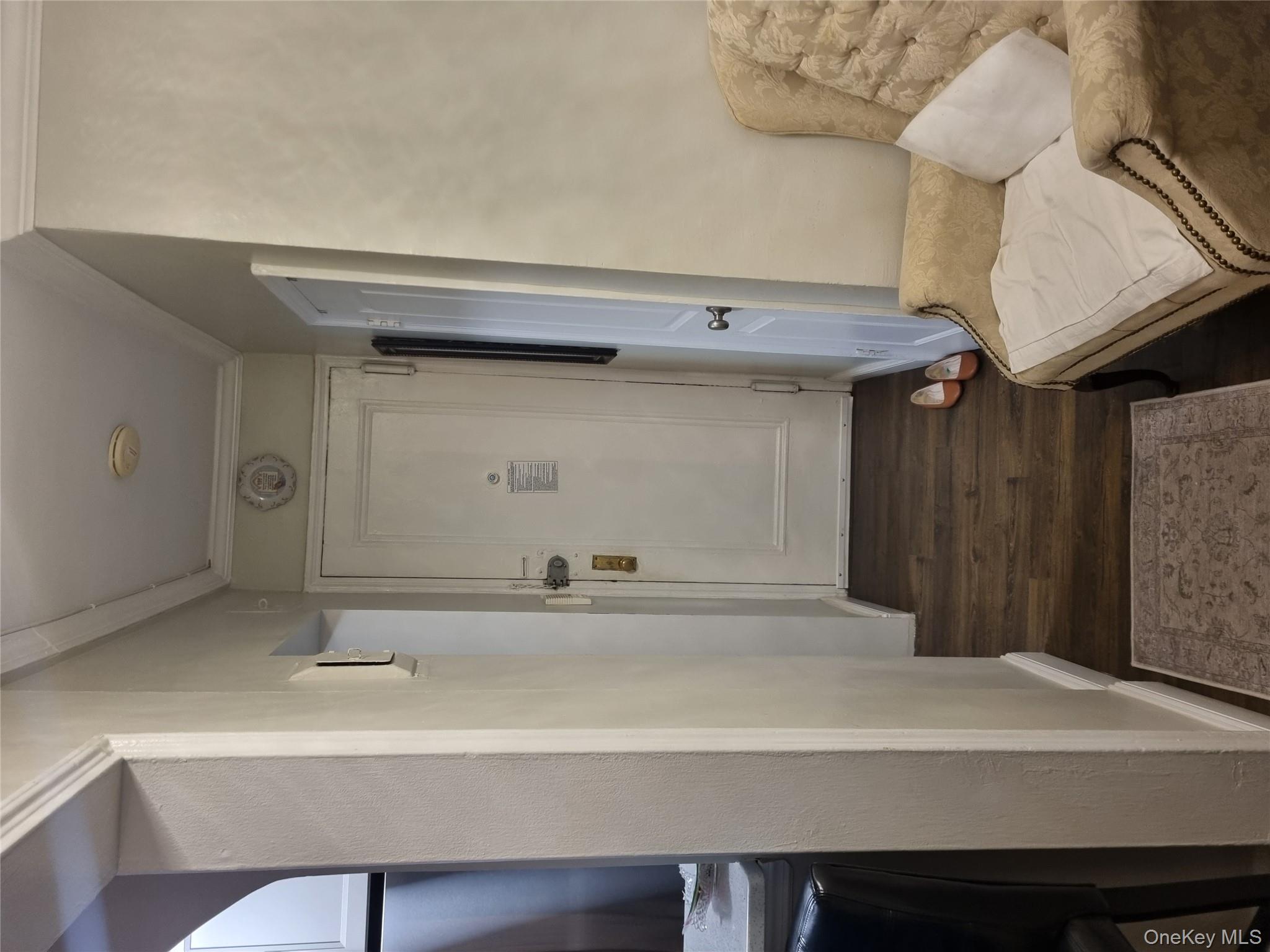 141-34 78th Avenue, Unit 1C Queens, NY 11367 - Photo 13 of 16 Hall featuring dark wood finished floors and ornamental molding