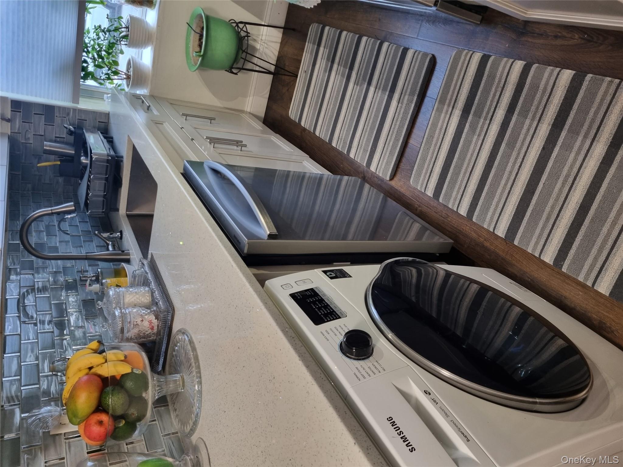 141-34 78th Avenue, Unit 1C Queens, NY 11367 - Photo 15 of 16 Laundry room featuring washer / clothes dryer and dark wood finished floors
