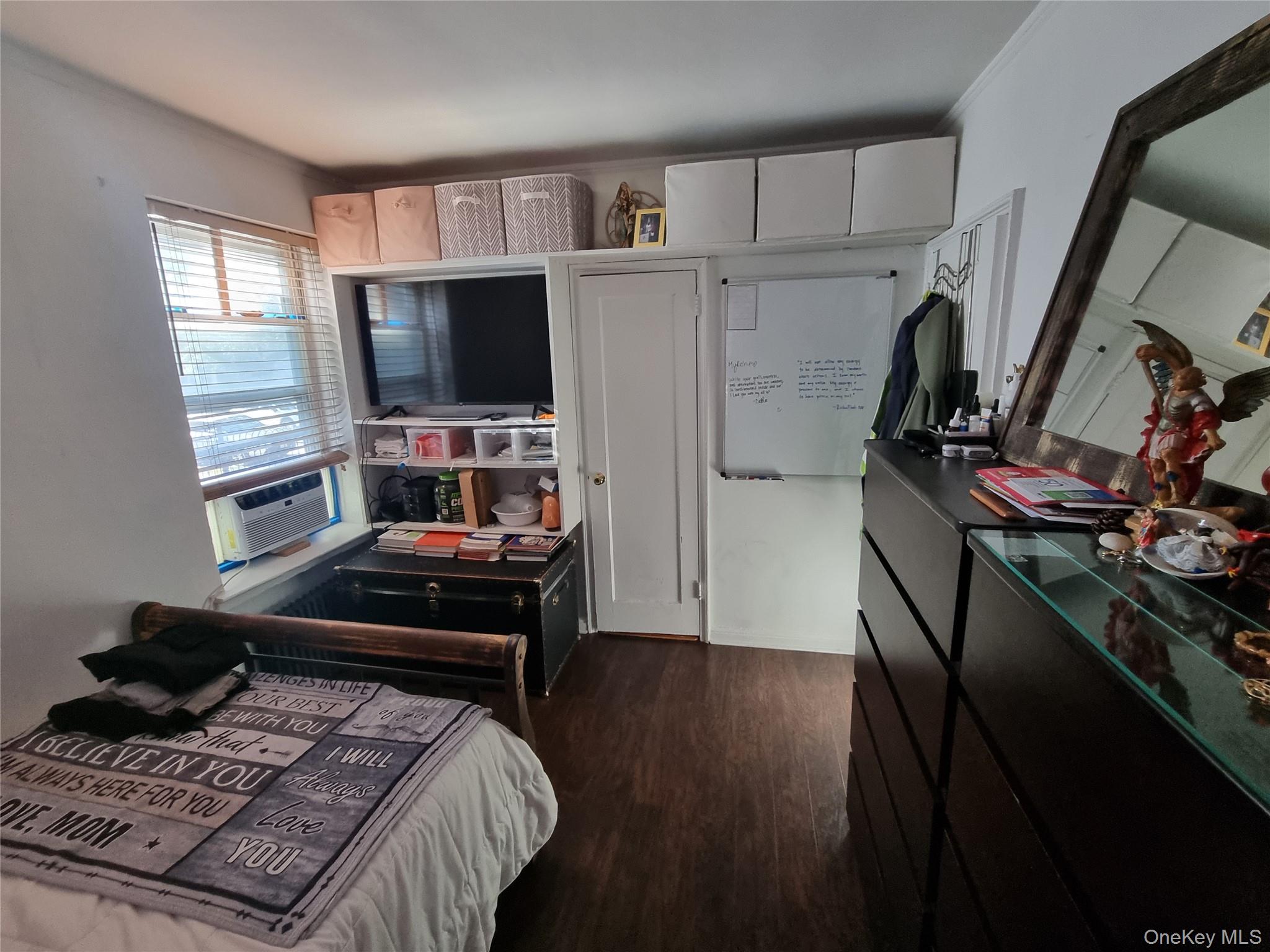 141-34 78th Avenue, Unit 1C Queens, NY 11367 - Photo 3 of 16 Bedroom with dark wood-type flooring and ornamental molding