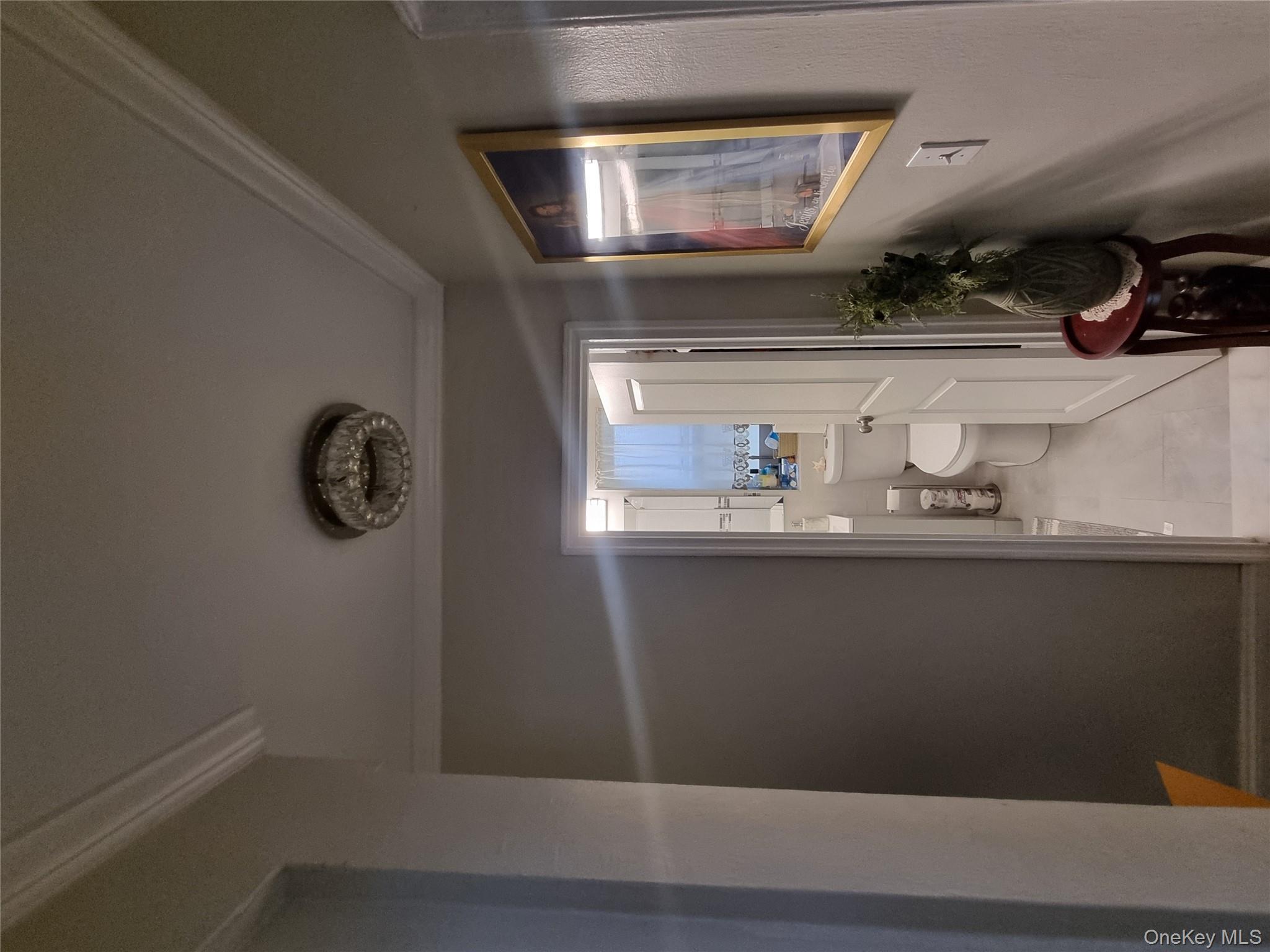 141-34 78th Avenue, Unit 1C Queens, NY 11367 - Photo 8 of 16 Corridor featuring crown molding and light tile patterned floors