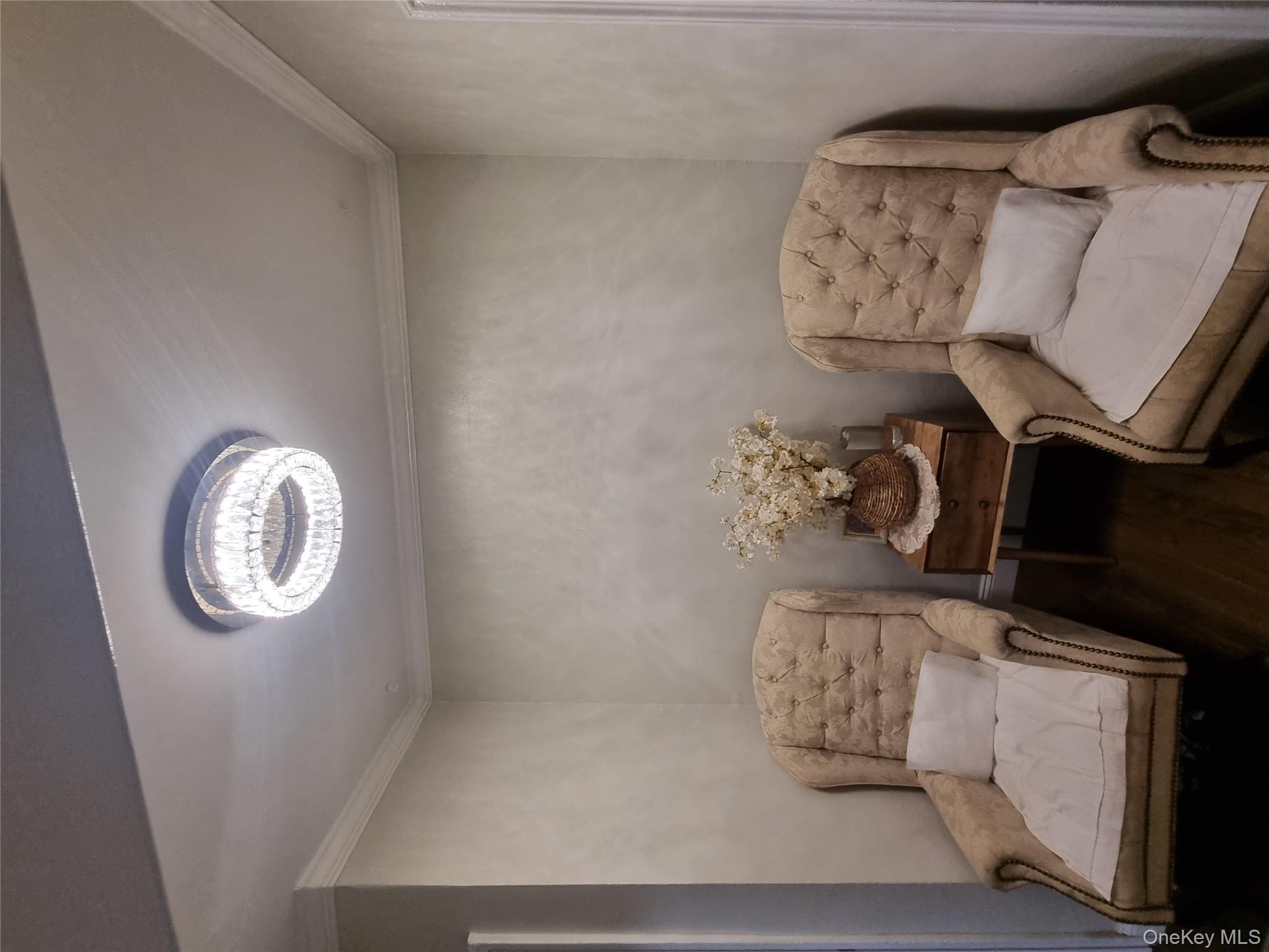 141-34 78th Avenue, Unit 1C Queens, NY 11367 - Photo 9 of 16 Sitting room featuring ornamental molding and dark wood-style flooring