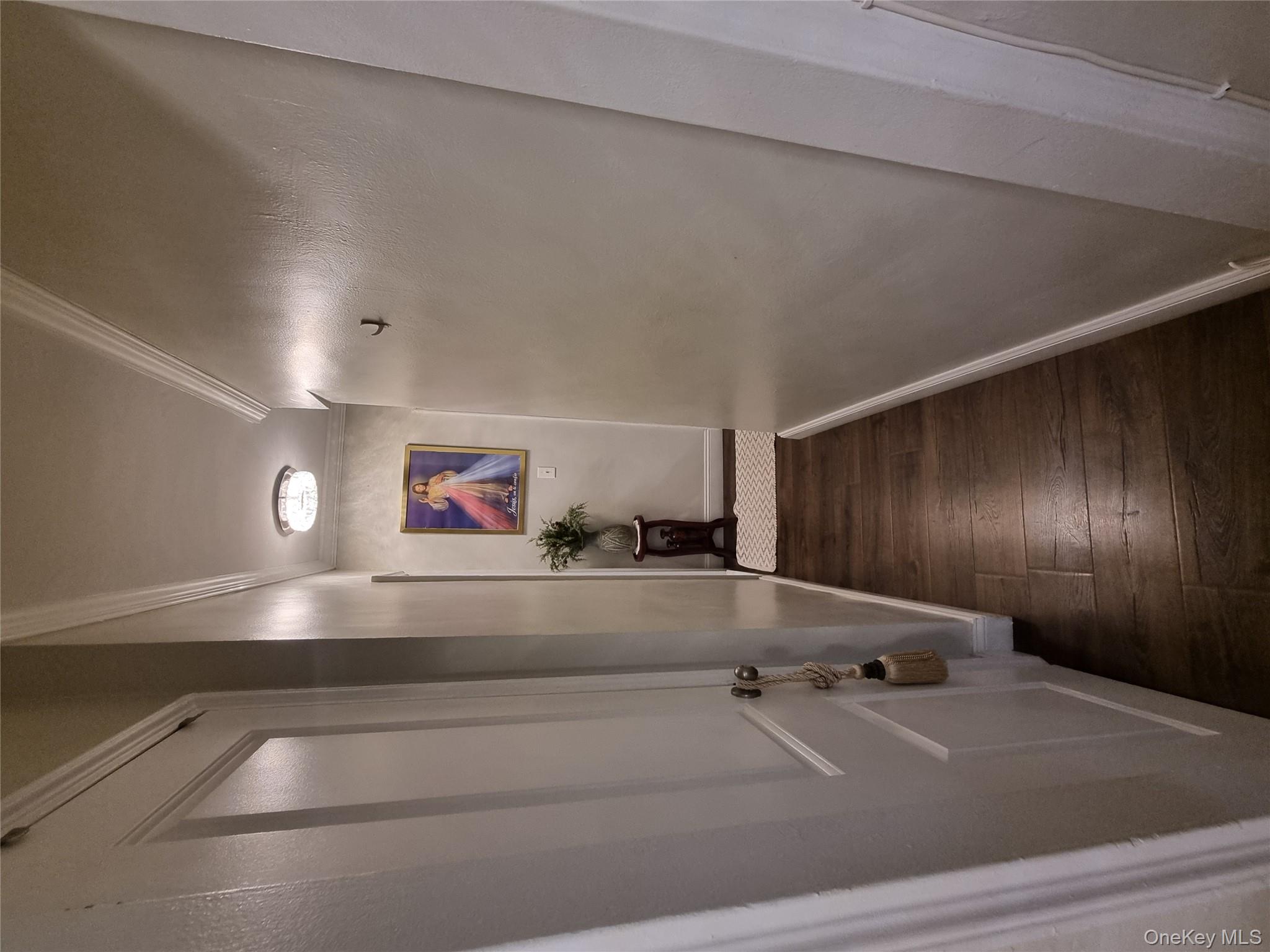 141-34 78th Avenue, Unit 1C Queens, NY 11367 - Photo 10 of 16 Hallway featuring dark wood-style floors and ornamental molding