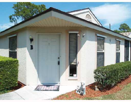 2826 Stoneway Lane, Unit B Fort Pierce, FL 34982 - Photo 1 of 7 a view of a white house with potted plants