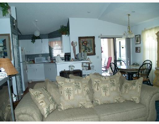 2826 Stoneway Lane, Unit B Fort Pierce, FL 34982 - Photo 2 of 7 a view of a kitchen with dining table and chairs