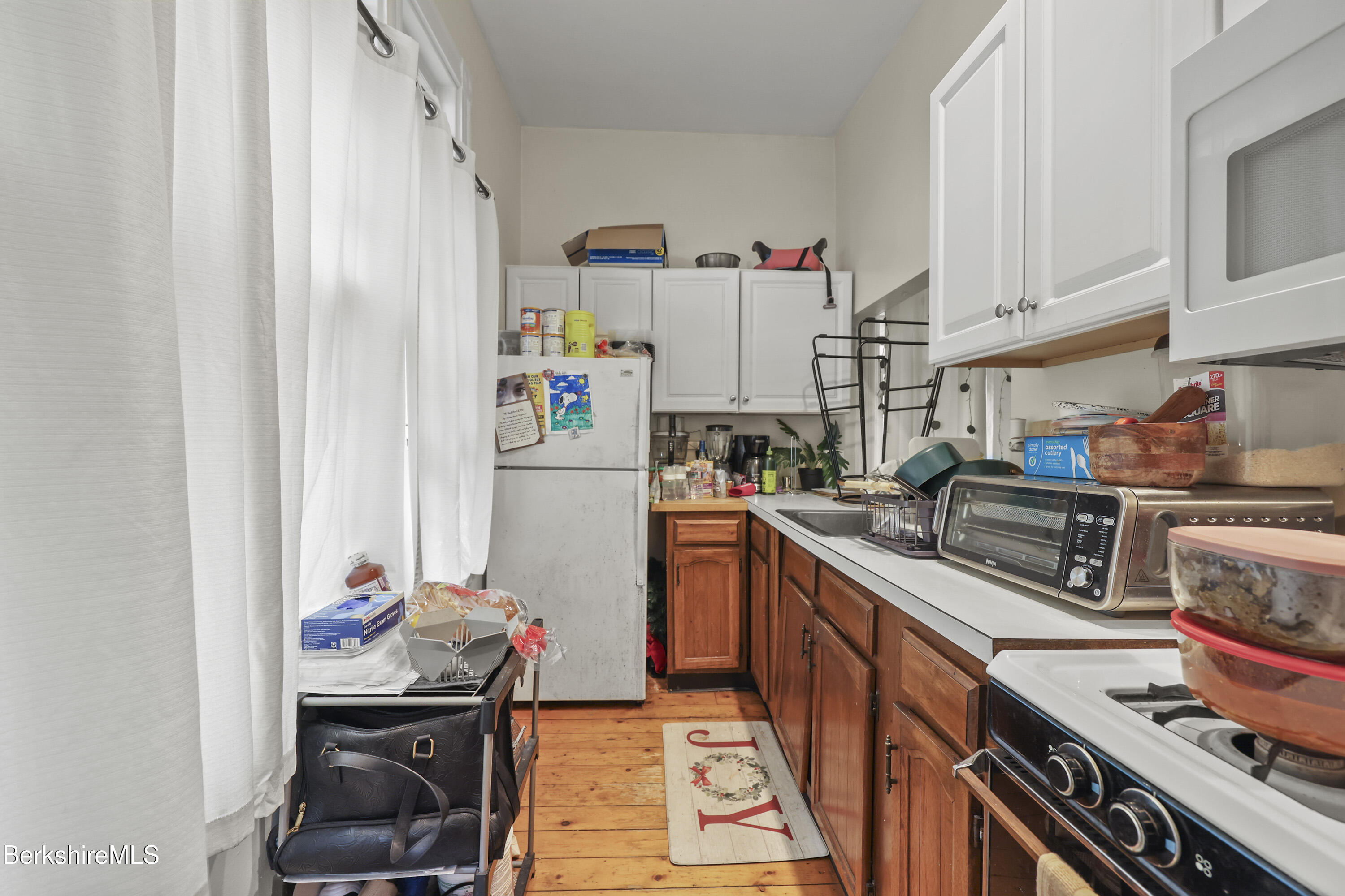 104 Appleton Avenue Pittsfield, MA 01201 - Photo 13 of 50 a kitchen with stainless steel appliances a sink a stove and a refrigerator