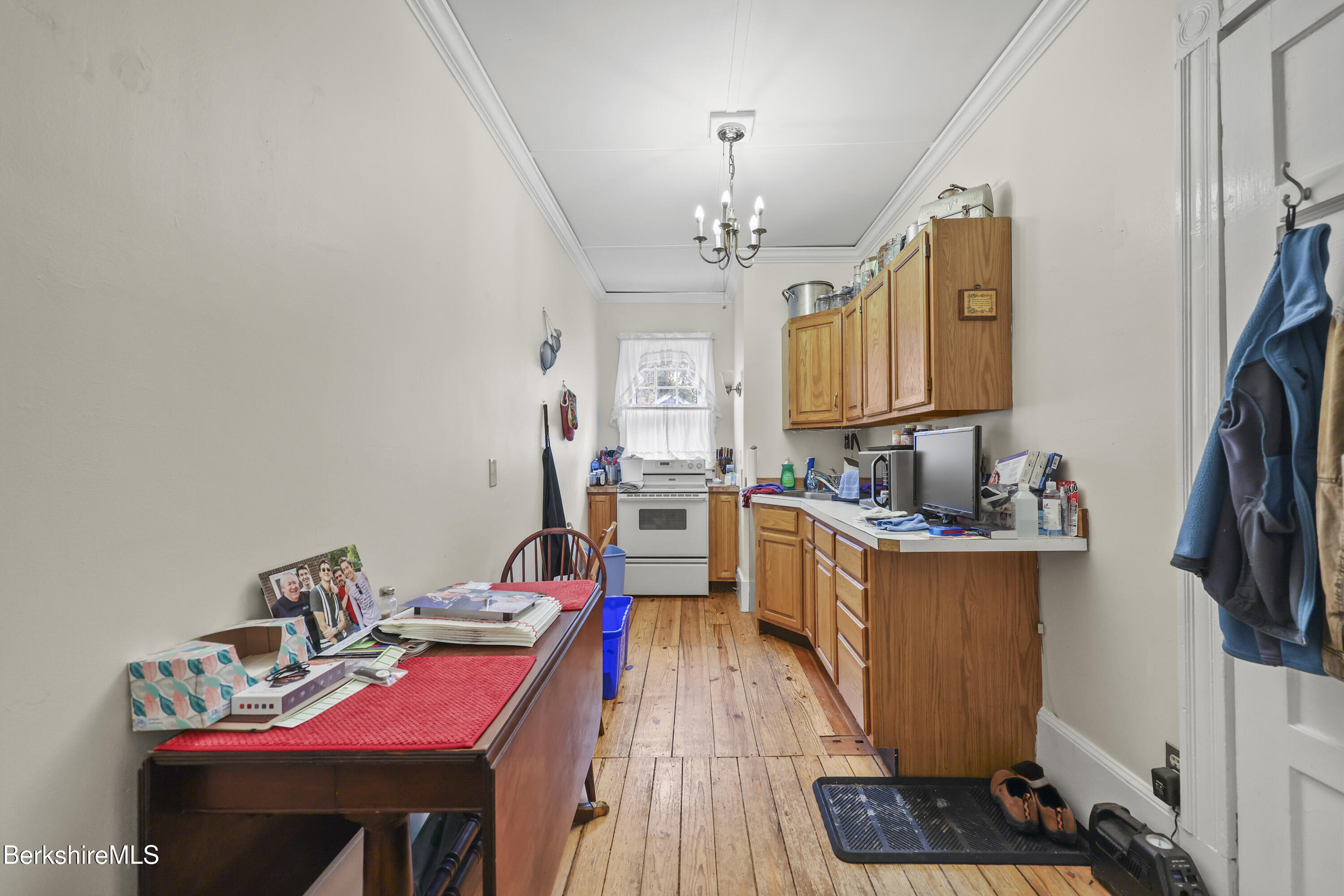 104 Appleton Avenue Pittsfield, MA 01201 - Photo 19 of 50 a kitchen that has a lot of cabinets a stove and a wooden floor
