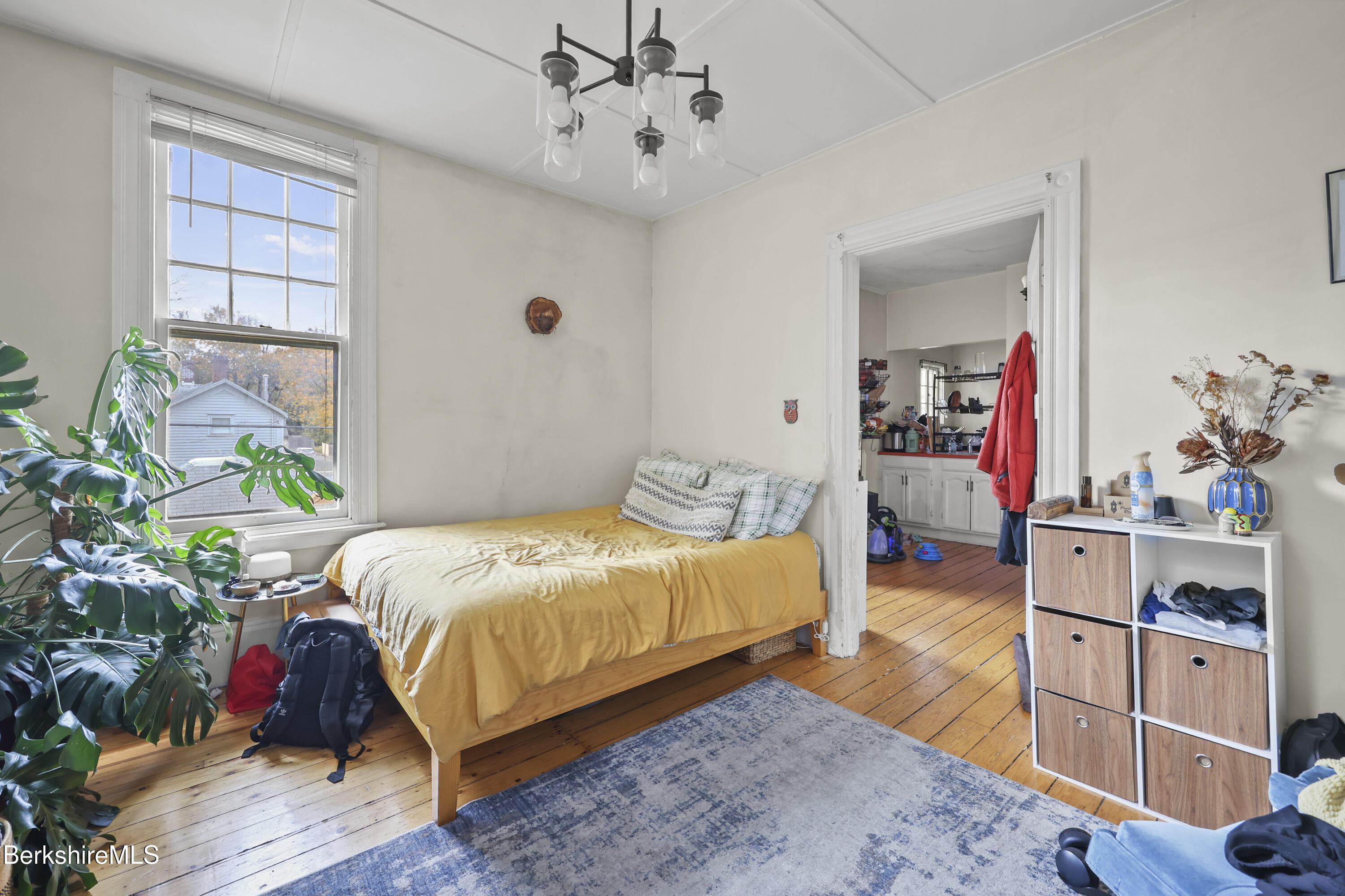 104 Appleton Avenue Pittsfield, MA 01201 - Photo 31 of 50 a bedroom with a bed chandelier and a window